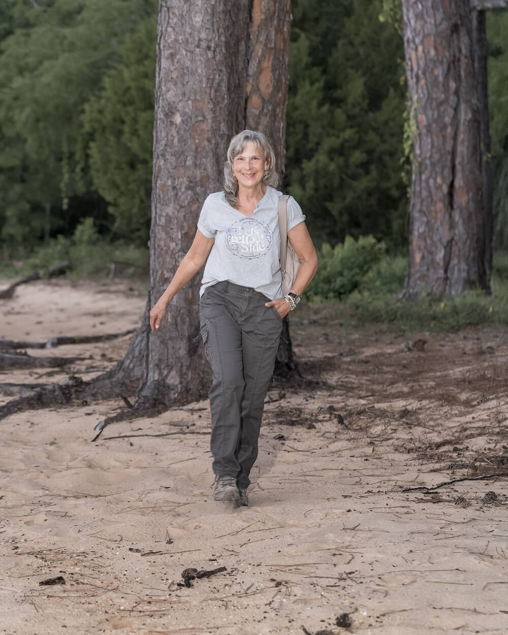 Cindy LeMoine walking through the woods