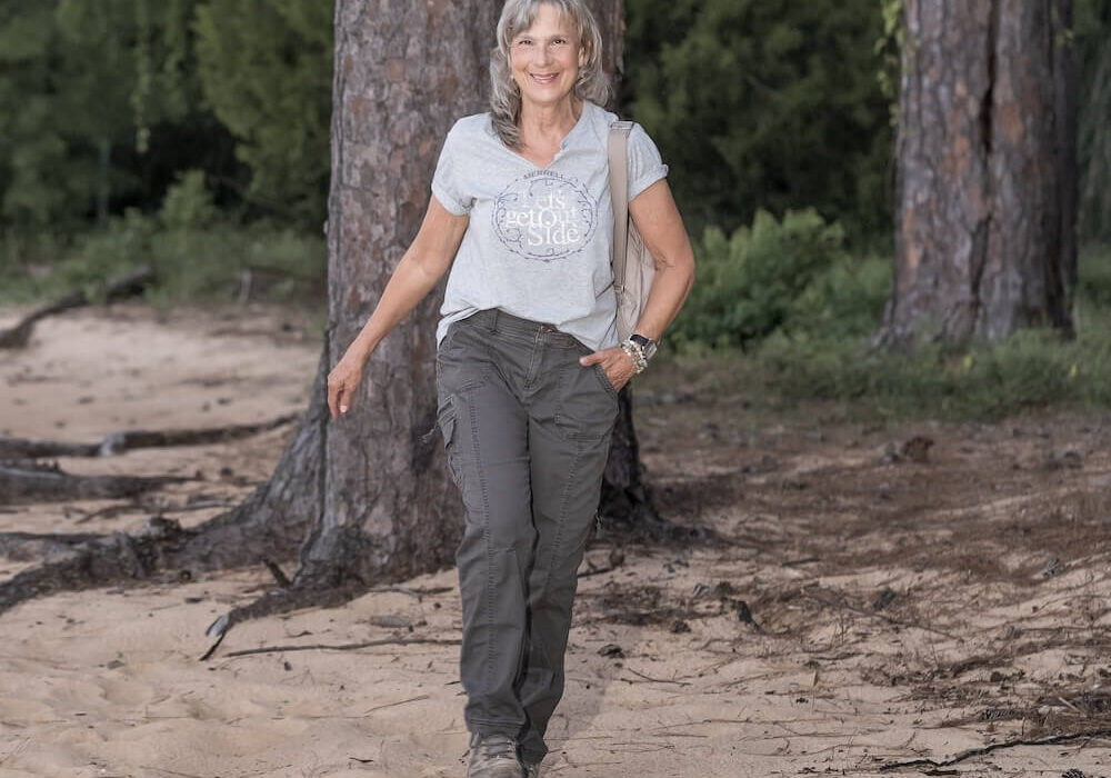 Cindy LeMoine walking through the woods